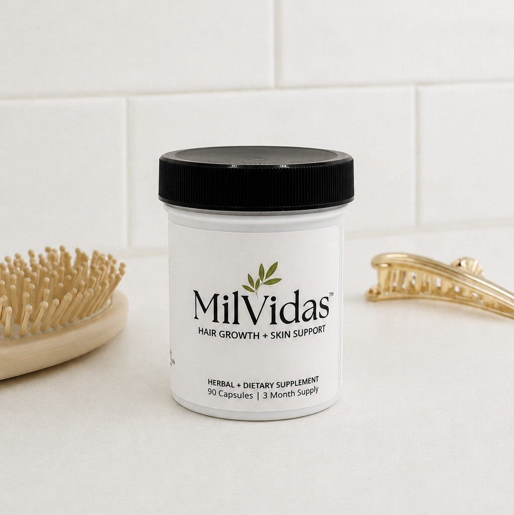 MilVidas supplement jar on a bathroom counter with a hairbrush and hair clips in the background.